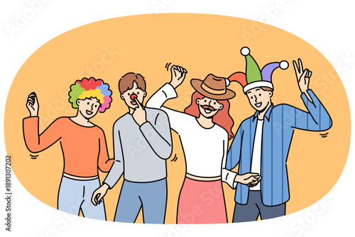 Group of friends participating in masquerade with funny hats or fake mustaches, dancing and enjoying festive party. Young men and women enjoy relaxing together at student party after end of session.