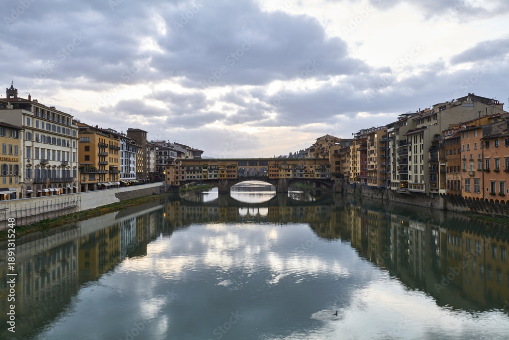 Fototapeta premium Ponte Vecchio Bridge under Dramatic Sky and Clouds in Florence Italy