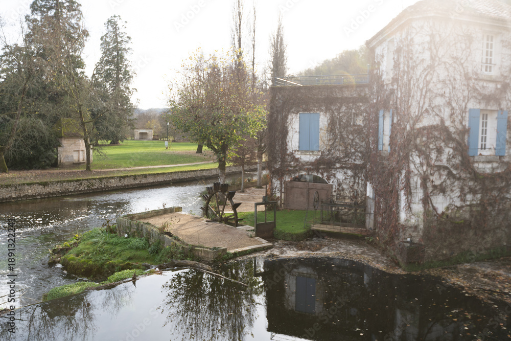 Naklejka premium Buildings small vineyard on the Dronne River, Brantome, Brantome-en-Perigord, France