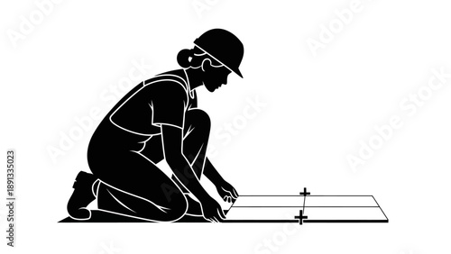 Woman kneeling and working on a project with a tool.