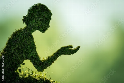 Green Hedge Silhouette Kneeling With Open Hand In Sunlit Outdoor Setting
