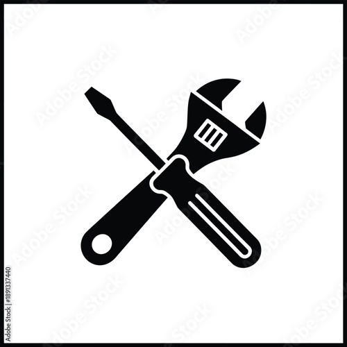 Black silhouette of a wrench and screwdriver crossed on white background