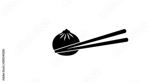 Black dumpling held by chopsticks on white background.