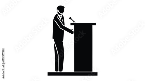 Suited speaker in silhouette leaning on podium with microphone in formal presentation setting