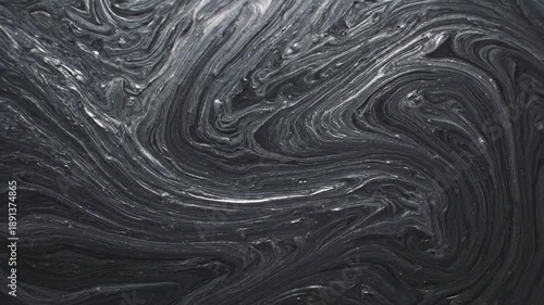 Swirling abstract pattern of black and gray lines creating a marbled, liquid, or cosmic effect