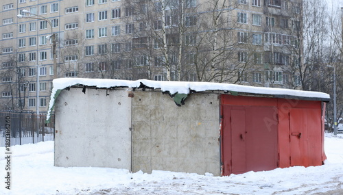 Concrete garage with metal doors in the courtyard of an apartment building