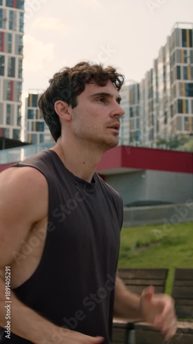 Focused Caucasian man running in city preparing for competition marathon guy male run strong athletic energetic healthy sportsman joining fast jog runner jogger doing sport cardio good morning habit