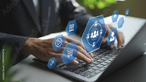 Omni channel concept showing a professional using a laptop with digital channel and customer icons. Integrating online and offline touchpoints to deliver seamless customer experiences.