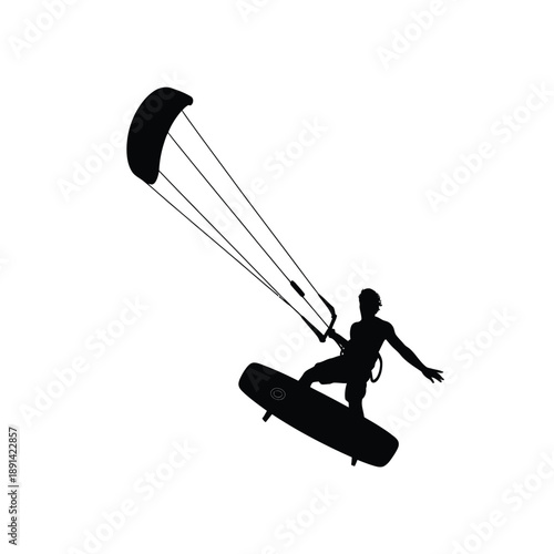 Silhouette of a kitesurfer soaring through the air on a wave