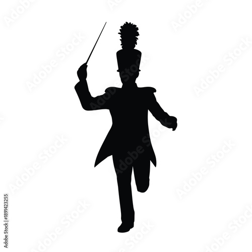 Silhouette of a marching band leader directing with a baton