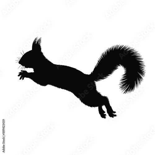 A black silhouette of a squirrel mid jump holding a nut