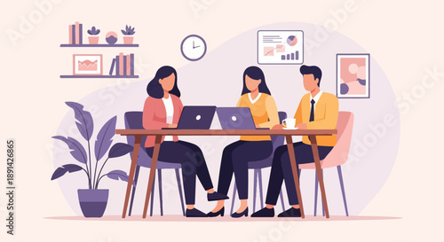 Colleagues collaborating on laptops in a modern office space with decorative elements