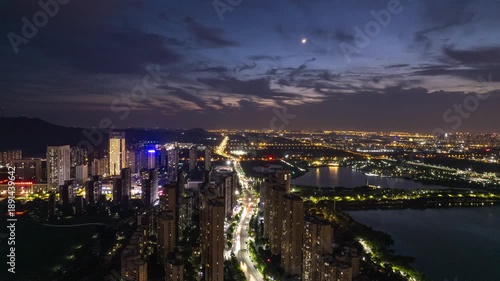 Wallpaper Mural Wuhan, China city skyline at dusk with bright lights illuminating the buildings and streets Torontodigital.ca
