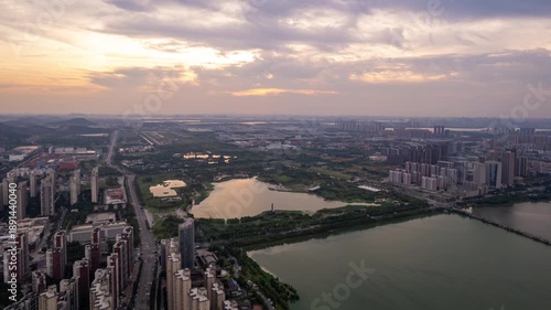 Aerial view of Wuhan, China, showcasing urban development and green spaces at dusk