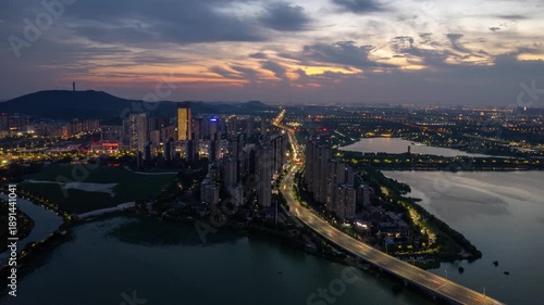 Wuhan China cityscape at dusk showing modern buildings and water reflections