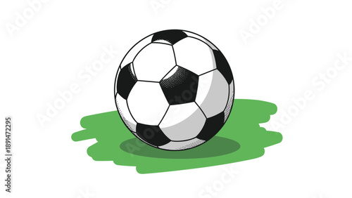 Classic black and white soccer ball sitting on a patch of green grass for various sports and game competition themes.