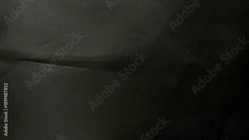 Photos folded black mesh fabric closeup texture subtle dots evoking mysterious depth sl