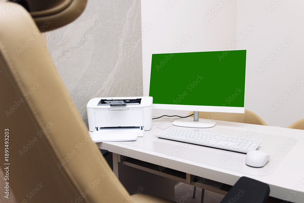 Fototapeta premium Modern home office workspace. Desktop computer with green screen monitor. White desk with printer and keyboard. Minimal interior design. Clean workplace setup with copy space.