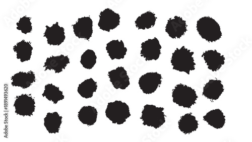 A collection of black ink spots on a white background