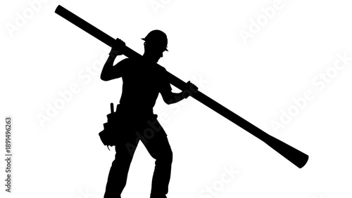 Silhouette of a Construction Worker Carrying a Long Pipe on His Shoulder.