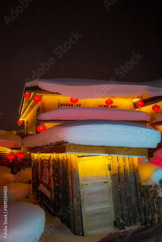 Snowy winter festival night market at Xuexiang China snow town. Dream home, Harbin.
