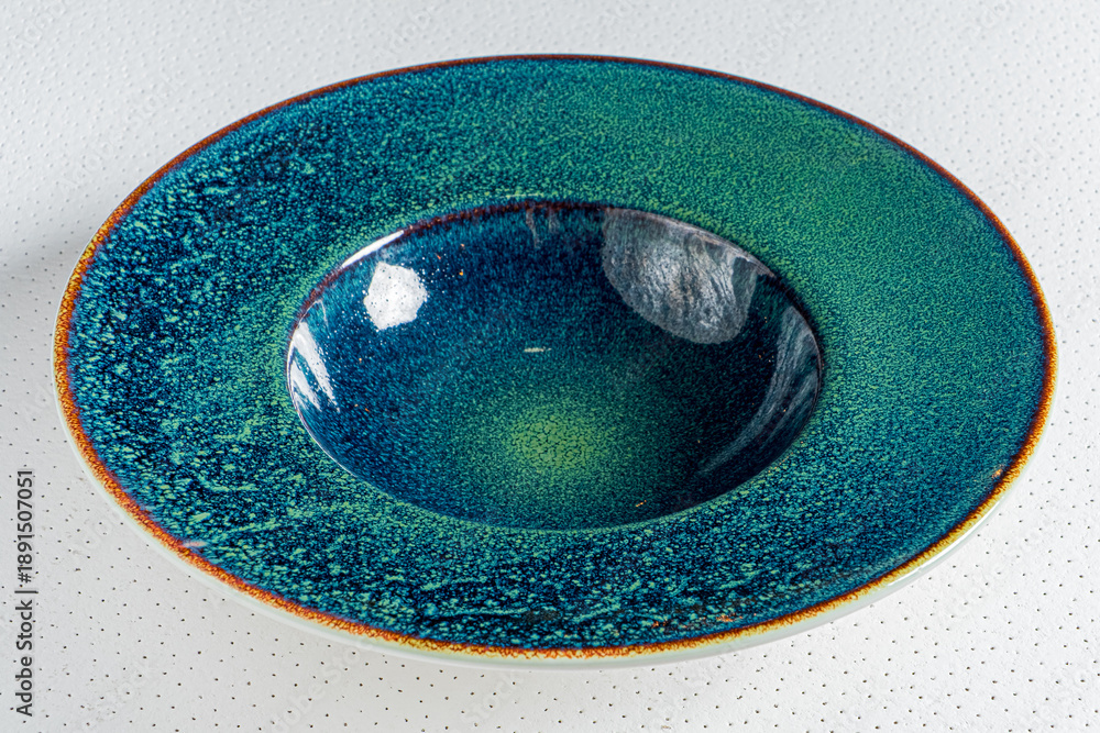 Fototapeta premium This beautiful ceramic bowl showcases deep blue and green colors in a captivating design
