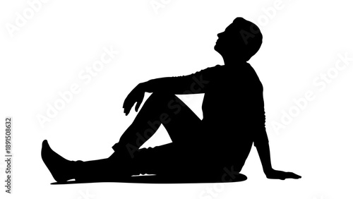 Silhouette of a man sitting and looking up thoughtfully.