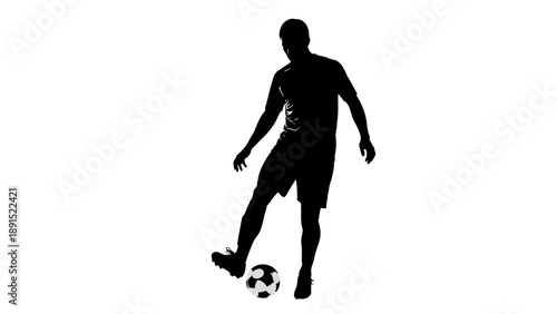 Silhouette of a soccer player dribbling a ball.