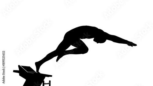 Silhouette of a swimmer diving off starting block.