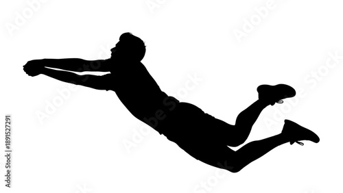 Silhouette of a volleyball player diving for the ball.
