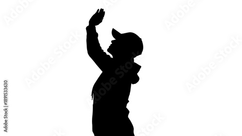 Silhouette of a person with a raised hand wearing a cap.