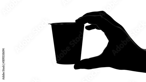 Silhouette of Hand Holding a Small Plastic Cup Against White Background.