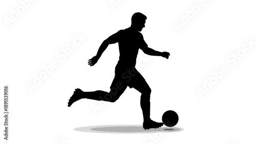 Silhouette of a soccer player kicking a ball during a game.