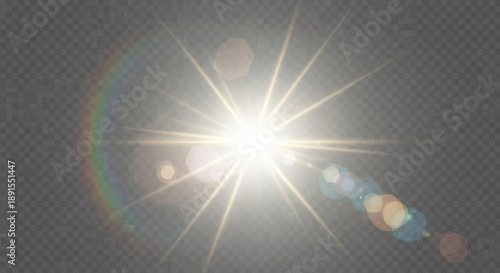 A bright sunburst with a rainbow effect on a dark gray background with lens flares and a white light center