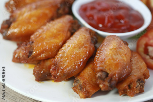 Wallpaper Mural Golden Wings and Flavor: Close-up of mouth-watering, golden-brown chicken wings on a plate. The wings are cooked to perfection with glistening skin. Torontodigital.ca