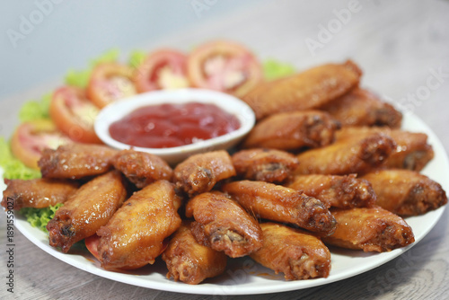 Wallpaper Mural Golden Wings: Savor the tantalizing appeal of crispy, golden-brown chicken wings artfully arranged with vibrant vegetables and a pool of rich, red sauce. A culinary masterpiece of texture and taste. Torontodigital.ca