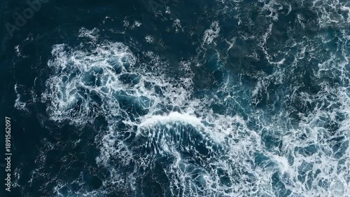 Seamless loop of rough sea during hurricane. Dark grey clouds with sun rays breaking through mist. Hyper-realistic 3D render of power of nature and climate disaster.
