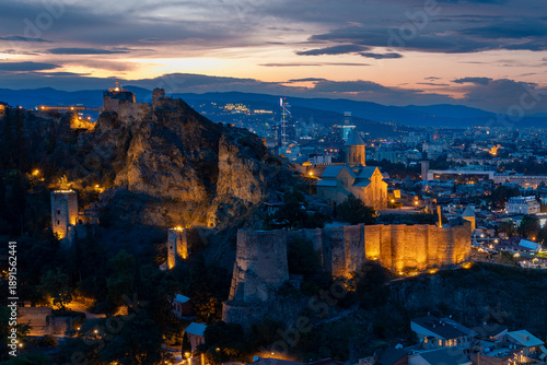 Illuminated Narikala Fortress And Church At Dusk In Tbilisi Georgia