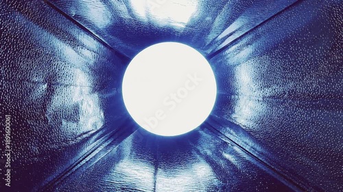 abstract blue reflective tunnel opening to glowing circular light with futuristic symmetry and immersive depth background