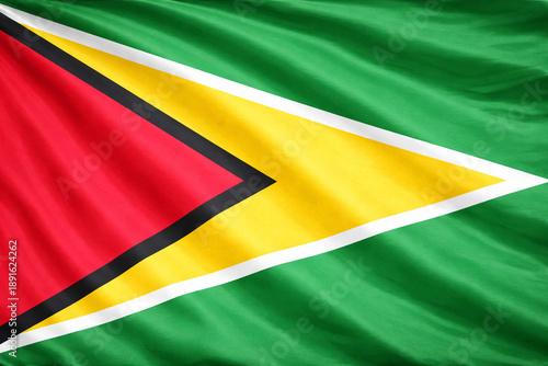 Guyana National Flag Waving in the Wind – Green Yellow Red Horizontal Fabric Background