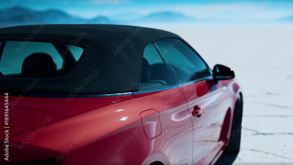 Naklejka premium A striking red convertible stands by itself on an expansive cracked ground, surrounded by distant mountains and a bright blue sky.