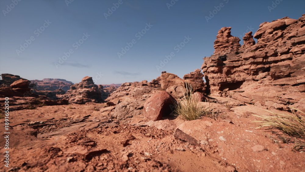 Fototapeta premium Vibrant rock formations rise majestically against a brilliant blue sky. Dried grasses sway gently in the warm breeze, creating a serene atmosphere in this expansive desert.