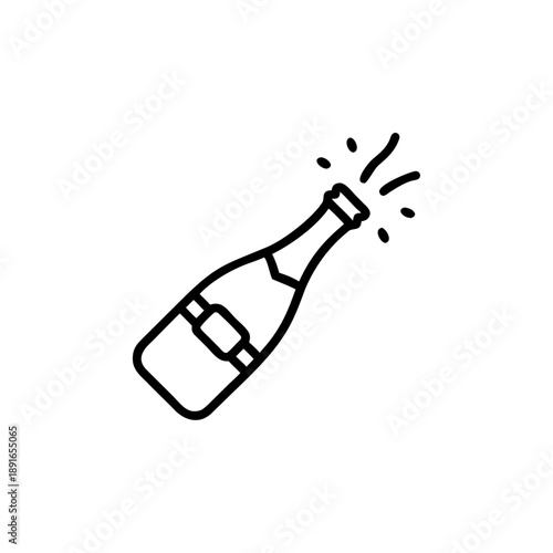 A happy message in a bottle floats in a glass of gold champagne to celebrate the New Year holiday beverage at a white party eve