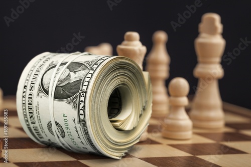 Chess figure on a chessboard and money