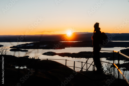 Woman Watching Sunset Over Tyrifjorden from Kongens Utsikt, Norway