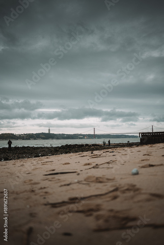 Urban beach near Lisbon with cloudy sky and calm atmosphere