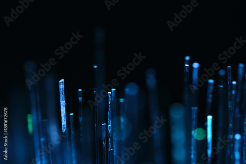 Sharp macro photography of cold blue optical fibers with bokeh light effects. Ideal for representing fiber to home and modern telecommunications.