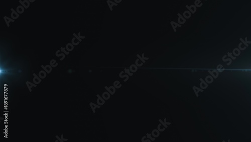 Canvas Print Abstract lens flare with light streak in dark background