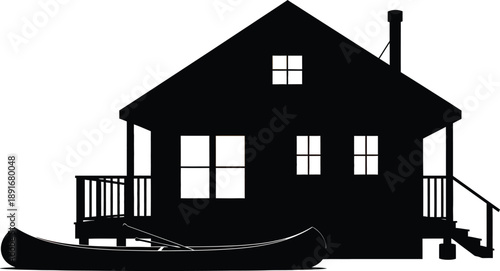 Black silhouette of a house with a canoe and porch