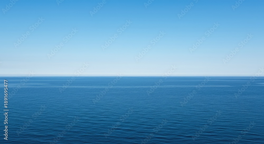 Obraz premium A vast expanse of deep blue water stretches toward the distant horizon under a bright summer sky, blending the scale of the sea with inland calm ,liquid ,blue ,travel